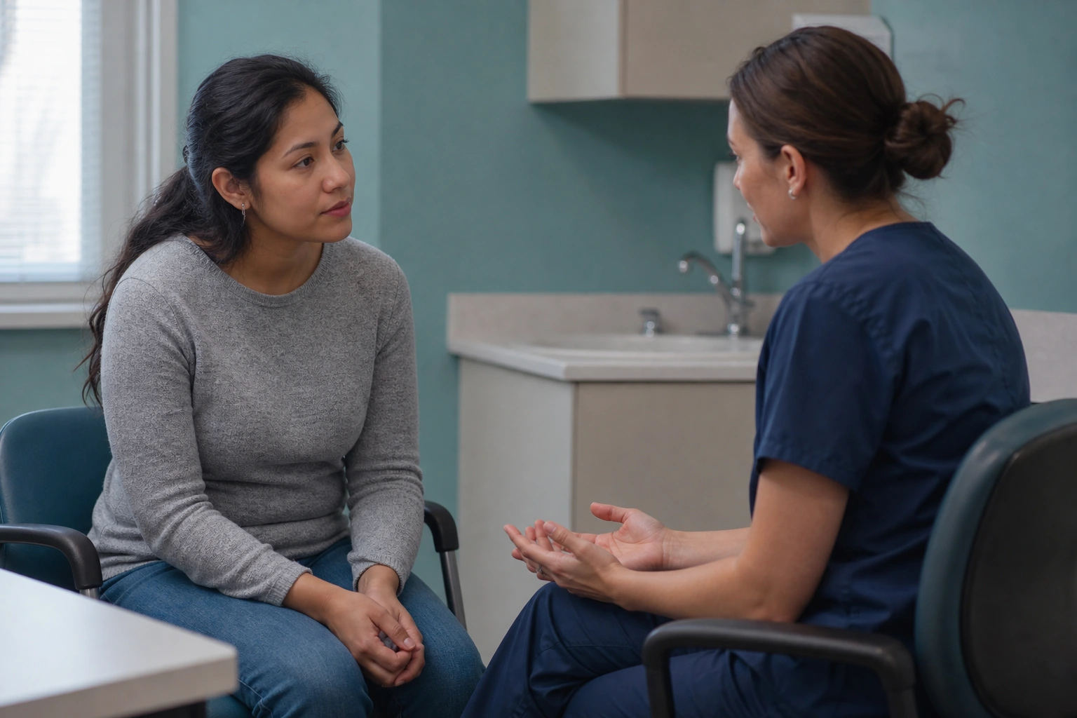An adult speaking privately with a clinician in a sexual-health consultation room