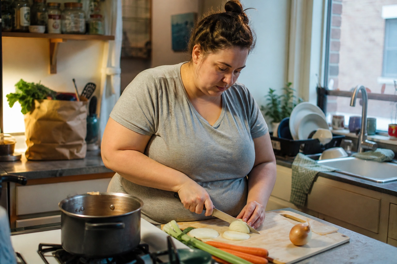 An adult preparing an ordinary weeknight meal in a lived-in kitchen